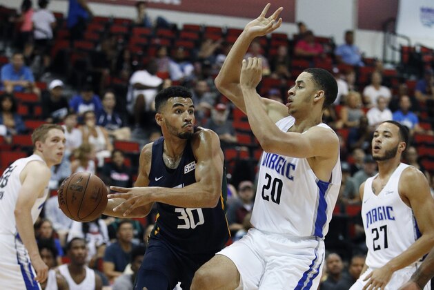 Utah Jazz's Naz Mitrou-Long passes the ball as Orlando Magic's Chance Comanche (20) defends during the second half of an NBA summer league basketball game Thursday, July 12, 2018, in Las Vegas. (AP Photo/John Locher)