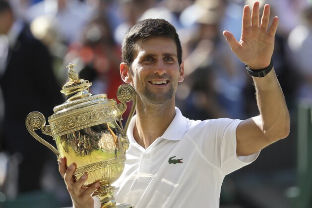 Serbia's Novak Djokovic holds the trophy after winning the men's singles final match against Kevin Anderson of South Africa, at the Wimbledon Tennis Championships, in London, Sunday July 15, 2018.(AP Photo/Kirsty Wigglesworth)