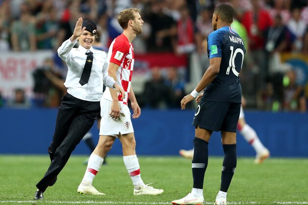 MOSCOW, RUSSIA - JULY 15:  A pitch invader runs towards Kylian Mbappe of France during the 2018 FIFA World Cup Final between France and Croatia at Luzhniki Stadium on July 15, 2018 in Moscow, Russia.  (Photo by Clive Rose/Getty Images)
