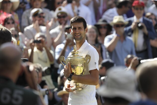 Serbia's Novak Djokovic holds the trophy after winning the men's singles final match against Kevin Anderson of South Africa, at the Wimbledon Tennis Championships, in London, Sunday July 15, 2018.(AP Photo/Kirsty Wigglesworth)