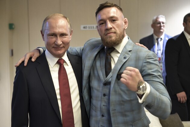 Russian President Vladimir Putin, left, and Ultimate fighting star Conor McGregor pose for a photo during the final match between France and Croatia at the 2018 soccer World Cup in the Luzhniki Stadium in Moscow, Russia, Sunday, July 15, 2018. (Alexei Nikolsky, Sputnik, Kremlin Pool Photo via AP)