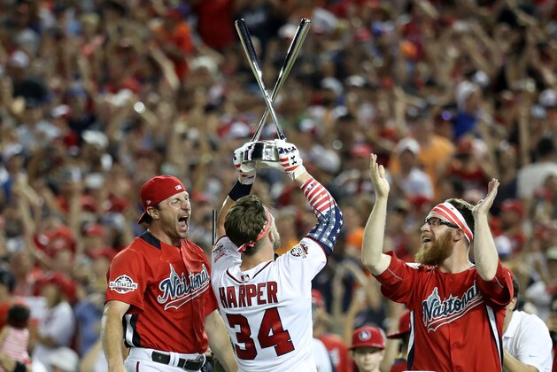 WASHINGTON, DC - JULY 16:  Bryce Harper of the Washington Nationals and National League celebrates with the trophy and teammates Max Scherzer #31 and Sean Doolittle #62 after winning the T-Mobile Home Run Derby at Nationals Park on July 16, 2018 in Washington, DC. Harper defeated Kyle Schwarber of the Chicago Cubs and National League 19-18.  (Photo by Rob Carr/Getty Images)