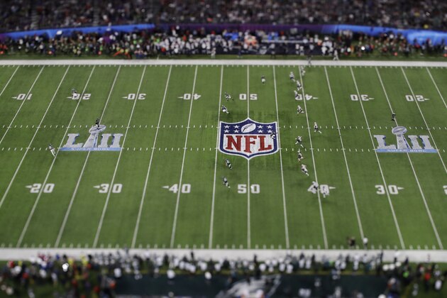 In this picture made with a specialty lens the New England Patriots kick off to the Philadelphia Eagles during the first half of the NFL Super Bowl 52 football game Sunday, Feb. 4, 2018, in Minneapolis. (AP Photo/Matt Slocum)