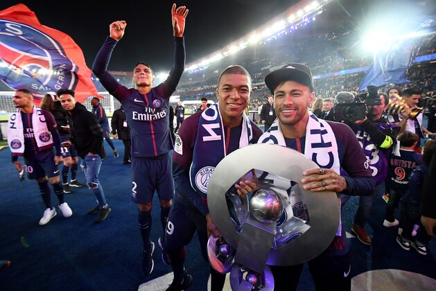Paris Saint-Germain's French forward Kylian MBappe (L) and Paris Saint-Germain's Brazilian forward Neymar pose with a trophy after winning the French L1 title at the end of the French L1 football match Paris Saint-Germain (PSG) vs Rennes on May 12, 2018 at the Parc des Princes stadium in Paris. (Photo by FRANCK FIFE / AFP)        (Photo credit should read FRANCK FIFE/AFP/Getty Images)