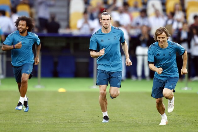 Real Madrid's Marcelo, Gareth Bale and Luka Modric, from left, run during a training session at the Olimpiyskiy Stadium in Kiev, Ukraine, Friday, May 25, 2018 ahead of the Champions League final soccer match between Real Madrid and Liverpool on Saturday May 26. (AP Photo/Matthias Schrader)