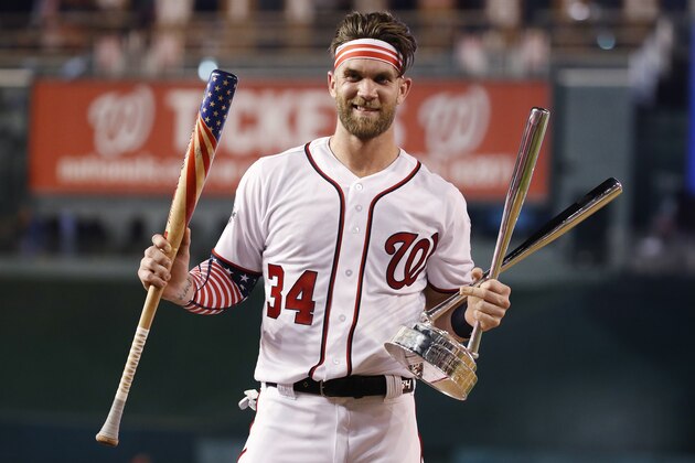 Washington Nationals Bryce Harper (34) holds his bat and the trophy after winning the Major League Baseball Home Run Derby Monday, July 16, 2018 in Washington. (AP Photo/Alex Brandon)
