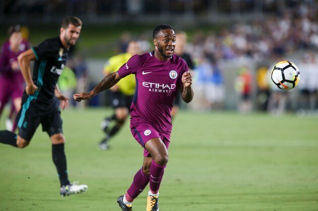 Manchester City midfielder Raheem Sterling, right, drives the ball against Real Madrid during the second half of the International Champions Cup match on July 26, 2017 in Los Angeles, California. 
Manchester City won 4-1.  / AFP PHOTO / RINGO CHIU        (Photo credit should read RINGO CHIU/AFP/Getty Images)