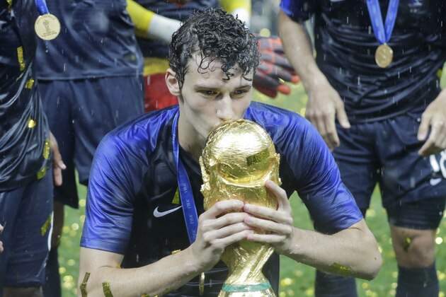 France's Benjamin Pavard kisses the trophy at the end during the final match between France and Croatia at the 2018 soccer World Cup in the Luzhniki Stadium in Moscow, Russia, Sunday, July 15, 2018. (AP Photo/Matthias Schrader)