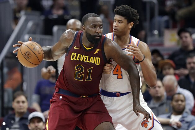 Cleveland Cavaliers' Kendrick Perkins (21) drives past New York Knicks' Isaiah Hicks (4) in the second half of an NBA basketball game, Wednesday, April 11, 2018, in Cleveland. The Knicks won 110-98. (AP Photo/Tony Dejak)