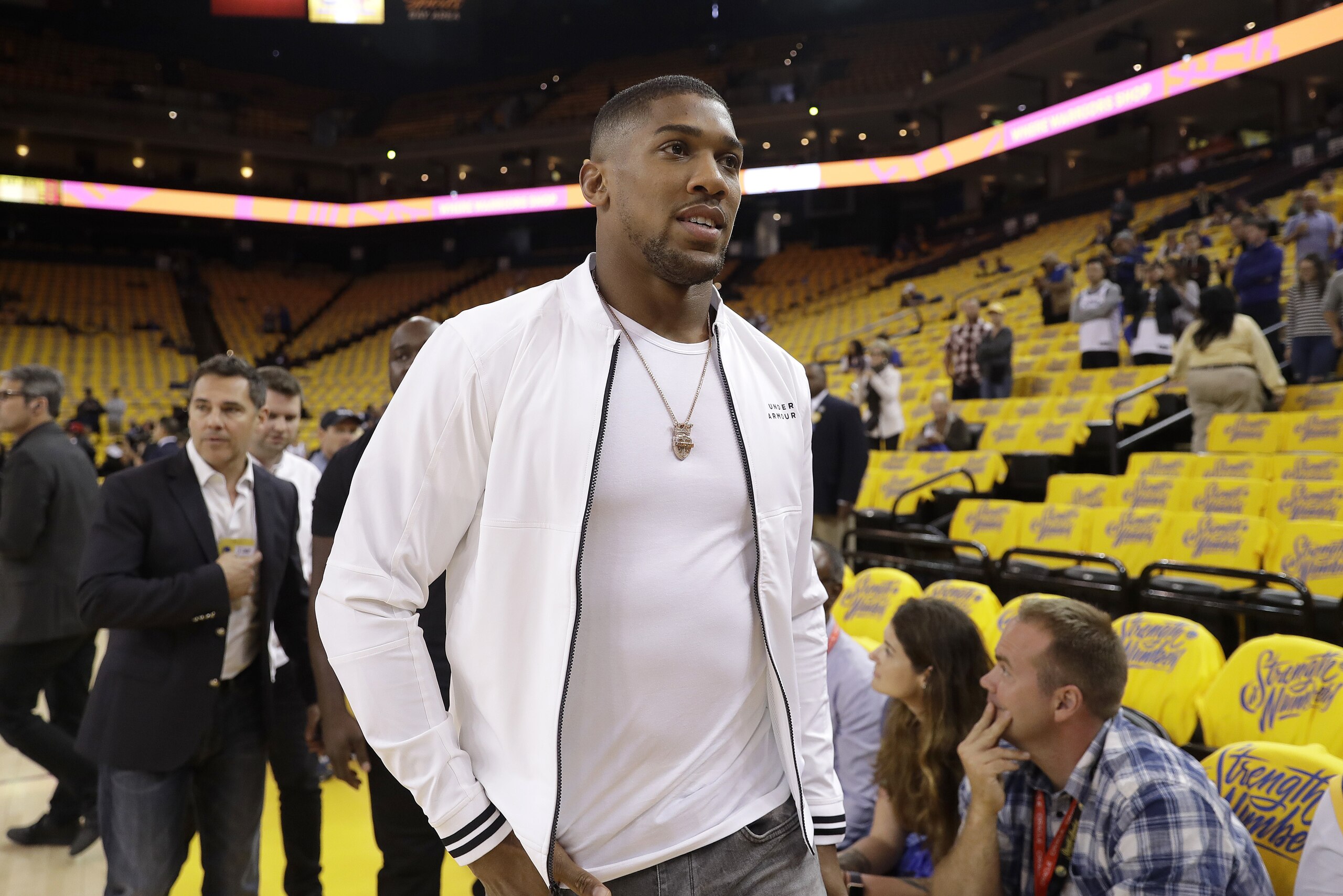 Boxer Anthony Joshua walks on the court before Game 4 of the NBA basketball Western Conference Finals between the Golden State Warriors and the Houston Rockets in Oakland, Calif., Tuesday, May 22, 2018. (AP Photo/Marcio Jose Sanchez)