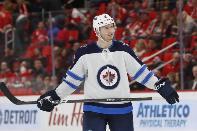 Winnipeg Jets defenseman Jacob Trouba (8) plays against the Detroit Red Wings in the third period of an NHL hockey game Tuesday, Dec. 5, 2017, in Detroit. (AP Photo/Paul Sancya)