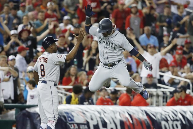 Seattle Mariners shortstop Jean Segura (2) celebrates his three-run homer in the eighth inning during the Major League Baseball All-star Game, Tuesday, July 17, 2018 in Washington. (AP Photo/Alex Brandon)