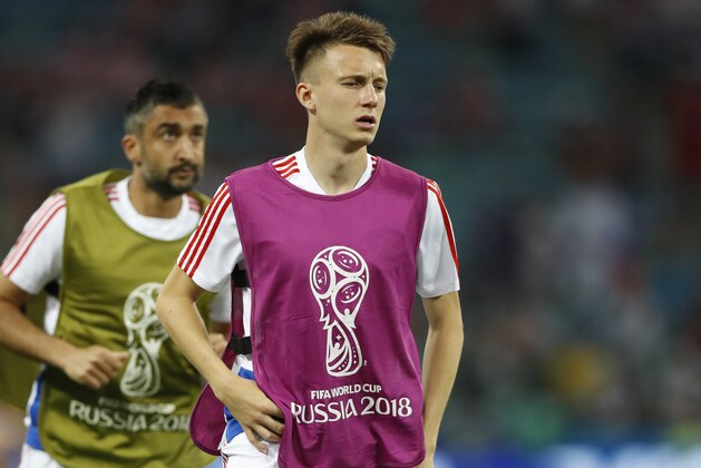 Russia's Alexander Golovin, centre, runs during warming up prior the quarterfinal match between Russia and Croatia at the 2018 soccer World Cup in the Fisht Stadium, in Sochi, Russia, Saturday, July 7, 2018. (AP Photo/Darko Bandic)
