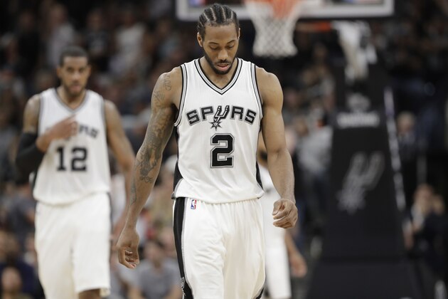 FILE - In this Tuesday, May 9, 2017, file photo, San Antonio Spurs forward Kawhi Leonard (2) and forward LaMarcus Aldridge (12) walk upcourt during the second half of Game 5 in a second-round NBA basketball playoff series against the Houston Rockets in San Antonio. Leonard will not play against Golden State in Game 3 of the Western Conference Finals on Saturday, May 20, 2017, due to a sprained left ankle. (AP Photo/Eric Gay, File)