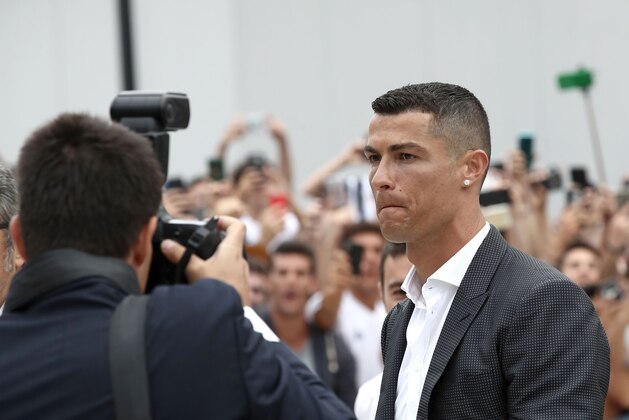 Portuguese footballer Cristiano Ronaldo walks out the Juventus medical center at the Alliance stadium in Turin on July 16, 2018 to greet supporters. - Cristiano Ronaldo arrived in Turin ahead of his official unveiling as Juventus' superstar summer signing on July 17. (Photo by Isabella Bonotto / AFP)        (Photo credit should read ISABELLA BONOTTO/AFP/Getty Images)
