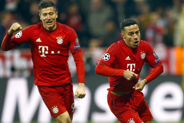 Bayern's scorer Thiago Alcantara, right, and his teammate Robert Lewandowski, left, celebrate their side's 3rd goal during the Champions League round of 16 second leg soccer match between FC Bayern Munich and Juventus Turin in Munich, southern Germany, Wednesday, March 16, 2016. (AP Photo/Matthias Schrader)
