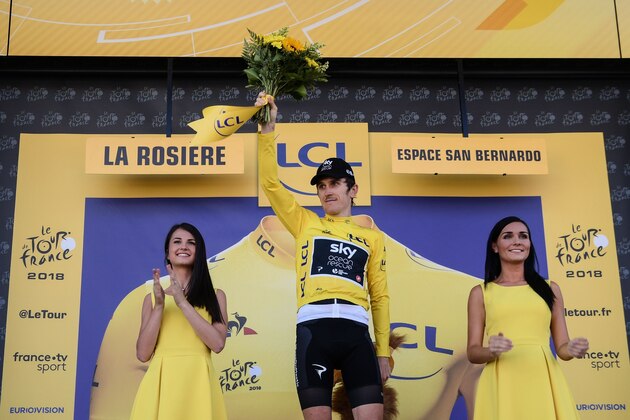 Great Britain's Geraint Thomas, wearing the overall leader's yellow jersey, celebrates on the podium after winning the eleventh stage of the 105th edition of the Tour de France cycling race between Albertville and La Rosiere, French Alps, on July 18, 2018. (Photo by Philippe LOPEZ / AFP)        (Photo credit should read PHILIPPE LOPEZ/AFP/Getty Images)