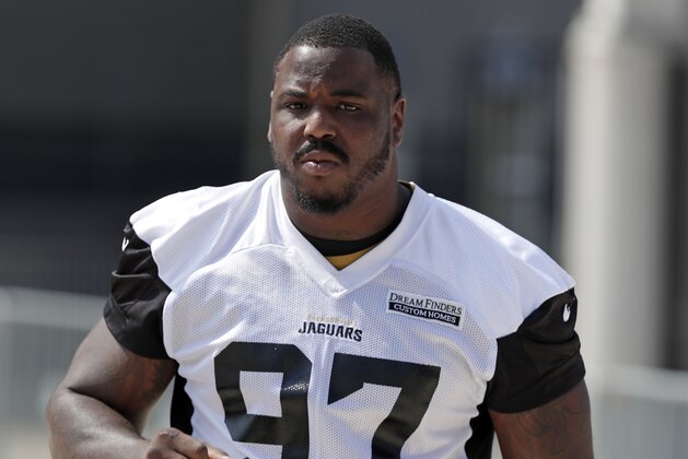 Jacksonville Jaguars defensive tackle Malik Jackson (97) heads to the field for an NFL football practice, Monday, June 4, 2018, in Jacksonville, Fla. (AP Photo/John Raoux)