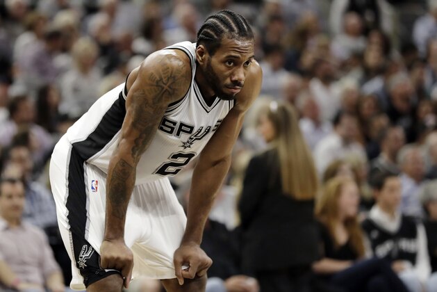 FILE - In this May 9, 2017, file photo, San Antonio Spurs' Kawhi Leonard (2) waits during a timeout in the first half in Game 5 of an NBA basketball second-round playoff series against the Houston Rockets in San Antonio. The waiting for Leonard's season debut continues. San Antonio's All-Star forward did not travel with the Spurs to Miami and will not play Wednesday against the Heat. (AP Photo/Eric Gay, File)