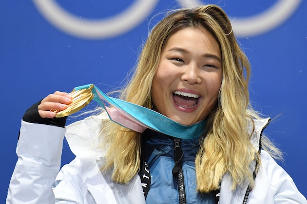TOPSHOT - USA's gold medallist Chloe Kim poses on the podium during the medal ceremony for the snowboard women's Halfpipe at the Pyeongchang Medals Plaza during the Pyeongchang 2018 Winter Olympic Games in Pyeongchang on February 13, 2018. / AFP PHOTO / Kirill KUDRYAVTSEV        (Photo credit should read KIRILL KUDRYAVTSEV/AFP/Getty Images)