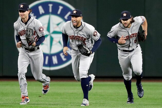 FILE - In this April 17, 2018, file photo, Houston Astros outfielders Josh Reddick, left, George Springer and Jake Marisnick race to the infield after they defeated the Seattle Mariners in a baseball game in Seattle. Houston outfielders have been celebrating victories this season by doing dances inspired by the Fortnite Battle Royale video game. (AP Photo/Elaine Thompson, File)