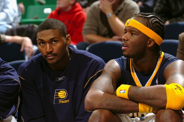 SALT LAKE CITY - NOVEMBER 29:  Ron Artest #15 and Jermaine O'Neal #7 of the Indiana Pacers sits on the sidelines during the game against the Utah Jazz on November 29, 2005 at the Delta Center in Salt Lake City, Utah.  The Pacers won 84-60. NOTE TO USER: User expressly acknowledges and agrees that, by downloading and/or using this Photograph, user is consenting to the terms and conditions of the Getty Images License Agreement. Mandatory Copyright Notice: Copyright 2005 NBAE  (Photo by Joe Murphy/NBAE via Getty Images)