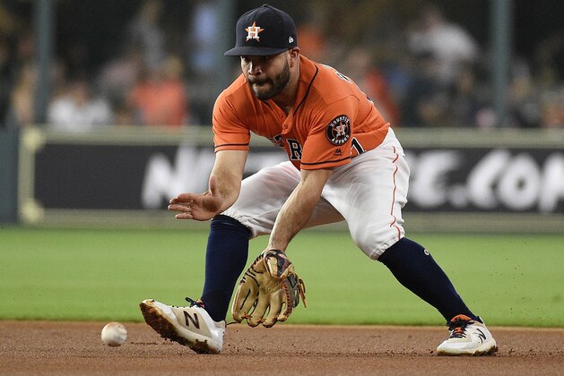 Houston Astros second baseman Jose Altuve fields a ground ball by Kansas City Royals' Mike Moustakas during the first inning of a baseball game, Friday, June 22, 2018, in Houston. Moustakas was out at first. (AP Photo/Eric Christian Smith)