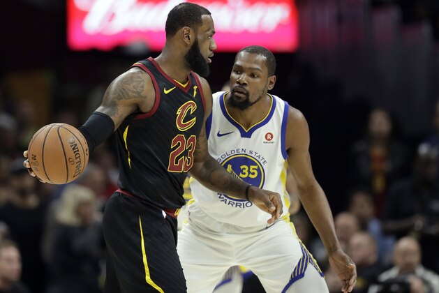 Cleveland Cavaliers' LeBron James is defended by Golden State Warriors' Kevin Durant in the first half of Game 3 of basketball's NBA Finals, Wednesday, June 6, 2018, in Cleveland. (AP Photo/Tony Dejak)