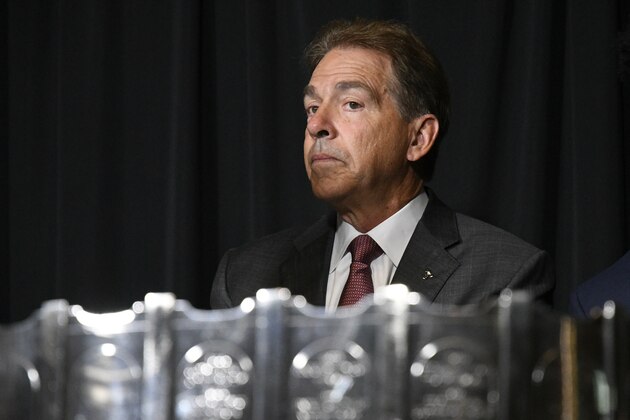 NCAA college football head coach Nick Saban of Alabama listens to the ceremony before being presented The MacArthur Bowl trophy, in front of him, during the Southeastern Conference Media Days at the College Football Hall of Fame in Atlanta, Wednesday, July 18, 2018. The trophy is presented annually, since 1959, to the top team in the country. (AP Photo/John Amis)
