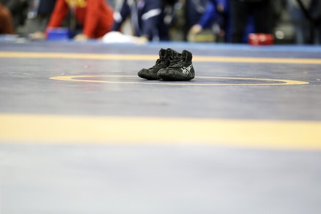 Spenser Mango's shoes sit on the center of the mat after losing to Jesse Thielke in their 59-kilogram Greco Roman match at the U.S. Olympic Wrestling Team Trials, Saturday, April 9, 2016, in Iowa City, Iowa. (AP Photo/Charlie Neibergall)