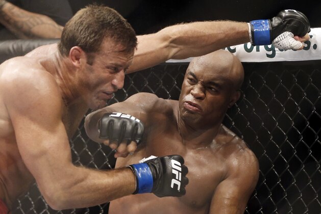 FILE - In this Oct. 14, 2012, file photo, Brazil's Anderson Silva, right, throws a punch at Stephan Bonnar, of the United States, during their light heavyweight mixed martial arts bout at UFC 153 in Rio de Janeiro, Brazil. Nevada fight regulators imposed the maximum penalty Thursday, Aug. 13, 2015 on former UFC champion Silva for testing positive for steroid use in January, 2015. Nevada Athletic Commission Chairman Francisco Aguilar said the 40-year-old Silva was suspended for one year, stripped of his January win over Nick Diaz and fined $380,000. (AP Photo/Felipe Dana, File)