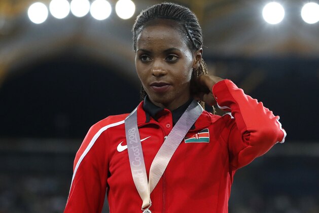Women's 1500m silver medalist Kenya's Beatrice Chepkoech stands on the podium at Carrara Stadium during the 2018 Commonwealth Games on the Gold Coast, Australia, Wednesday, April 11, 2018. (AP Photo/Mark Schiefelbein)
