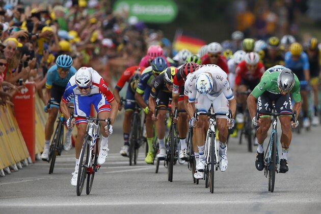 Stage winner Slovakia's Peter Sagan, wearing the best sprinter's green jersey, right, crosses the finish line ahead of Norway's Alexander Kristoff, center, and France's Arnaud Demare, left, during the thirteenth stage of the Tour de France cycling race over 169.5 kilometers (105.3 miles) with start in Bourg d'Oisans and finish in Valence, France, Friday July 20, 2018. (AP Photo/Peter Dejong)