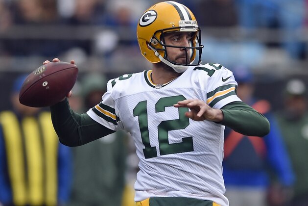 FILE - In this Dec. 17, 2017, file photo, Green Bay Packers' Aaron Rodgers looks to pass against the Carolina Panthers during the first half of an NFL football game in Charlotte, N.C. The Green Bay Packers opened on-field work in their offseason program this week, an especially important time for a team that has had a lot of changes since the end of a 7-9 season. On offense, Aaron Rodgers is healthy again after missing much of last season with a broken collarbone.. (AP Photo/Mike McCarn, File)