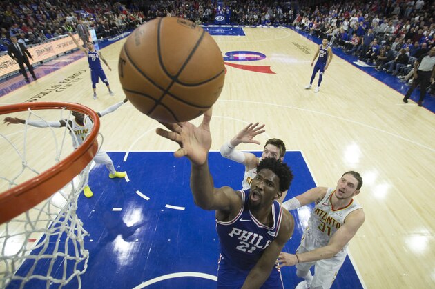PHILADELPHIA, PA - NOVEMBER 1: Joel Embiid #21 of the Philadelphia 76ers attempts a lay up against Luke Babbitt #8 and Mike Muscala #31 of the Atlanta Hawks in the fourth quarter at the Wells Fargo Center on November 1, 2017 in Philadelphia, Pennsylvania. NOTE TO USER: User expressly acknowledges and agrees that, by downloading and or using this photograph, User is consenting to the terms and conditions of the Getty Images License Agreement. The 76ers defeated the Hawks 119-109. (Photo by Mitchell Leff/Getty Images)
