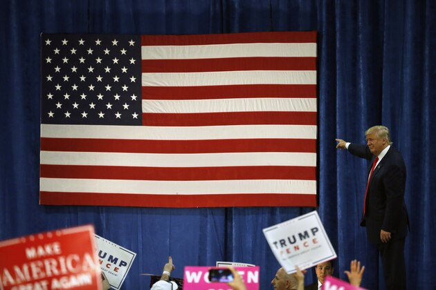 Republican presidential candidate Donald Trump points to the American flag after speaking at a campaign rally at the University of Northern Colorado, in Greeley, Colo., Sunday, Oct. 30, 2016. (AP Photo/ Brennan Linsley)