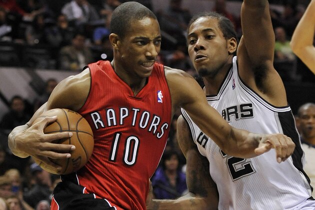 Toronto Raptors guard DeMar DeRozan, left, drives around San Antonio Spurs forward Kawhi Leonard during the second half of an NBA basketball game on Monday, Dec. 23, 2013, in San Antonio. San Antonio won 112-99. (AP Photo/Darren Abate)