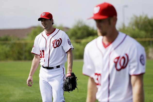 Washington Nationals pitchers Max Scherzer, left, and Stephen Strasburg walk on the field during a spring training baseball workout, Sunday, March 1, 2015, in Viera, Fla. (AP Photo/David Goldman)