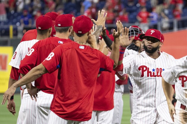 Philadelphia Phillies' Carlos Santana, right, celebrates with teammates after a baseball game against the San Diego Padres, Friday, July 20, 2018, in Philadelphia. The Phillies won 11-5. (AP Photo/Chris Szagola)