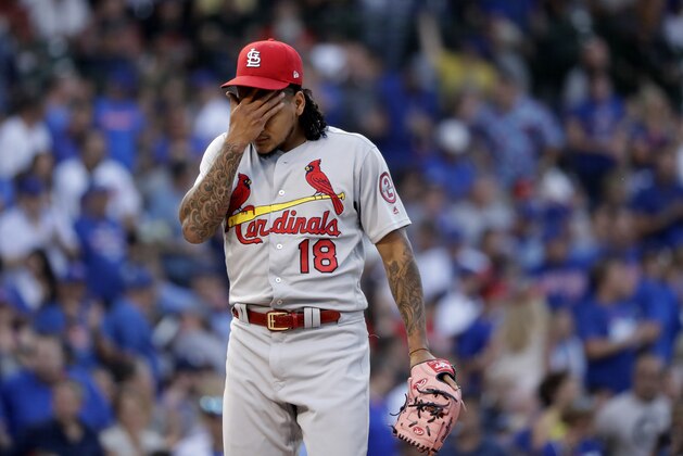 St. Louis Cardinals starting pitcher Carlos Martinez wipes his face after giving up a run during the third inning of a baseball game against the Chicago Cubs, Thursday, July 19, 2018, in Chicago. (AP Photo/Charles Rex Arbogast)