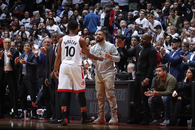 TORONTO, CANADA - APRIL 17: DeMar DeRozan #10 of the Toronto Raptors and Drake react to a play during the game against the Washington Wizards in Game Two of Round One of the 2018 NBA Playoffs on April 17, 2018 at the Air Canada Centre in Toronto, Ontario, Canada. NOTE TO USER: User expressly acknowledges and agrees that, by downloading and or using this Photograph, user is consenting to the terms and conditions of the Getty Images License Agreement. Mandatory Copyright Notice: Copyright 2018 NBAE (Photo by Mark Blinch/NBAE via Getty Images)