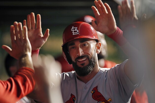 St. Louis Cardinals' Matt Carpenter is congratulated after hitting a home run during the seventh inning of the second baseball game of a doubleheader against the Chicago Cubs on Saturday, July 21, 2018, in Chicago. (AP Photo/Jim Young)