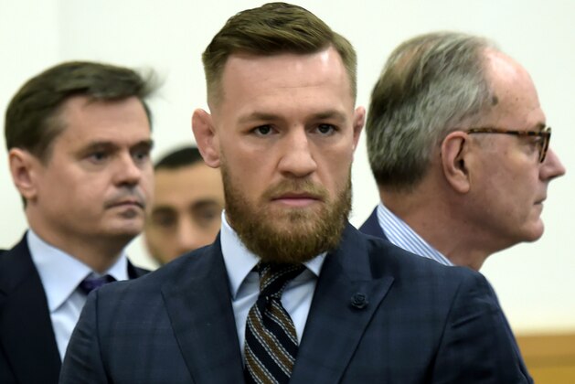 Mixed martial arts fighter Conor McGregor, center, arrives at Brooklyn Supreme Court, Thursday, June 14, 2018, in New York. McGregor expressed regret on Thursday for a backstage melee at a Brooklyn arena, and is in plea negotiations to resolve charges in the case. (Rashid Umar Abbasi /New York Post via AP, Pool)