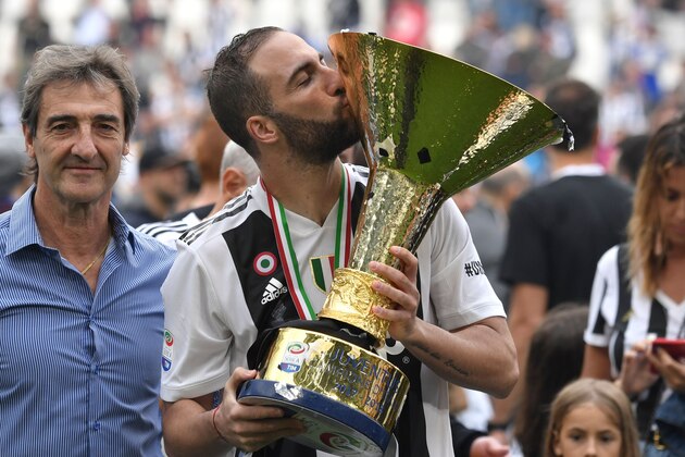 Juventus' forward from Argentina Gonzalo Higuain kisses the trophy during the victory ceremony following the Italian Serie A last football match of the season Juventus versus Verona, on May 19, 2018 at the Allianz Stadium in Turin. Juventus won their 34th Serie A title (scudetto) and seventh in succession. (Photo by Andreas SOLARO / AFP)        (Photo credit should read ANDREAS SOLARO/AFP/Getty Images)