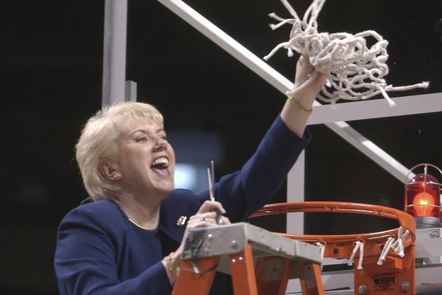 FILE - In this March 2, 2003 file photo Penn State women's basketball coach Rene Portland waves the net she cut down to celebrate their Big 10 regular season championship after defeating Wisconsin in State College, Pa. Portland, who built Penn State into a women's basketball powerhouse during a 27-year tenure, has died after a three-year fight with cancer. She was 65. D'Anjolell Memorial Home of Broomall in Pennsylvania confirmed her death Sunday, July 22, 2018. (AP Photo/Pat Little, file)