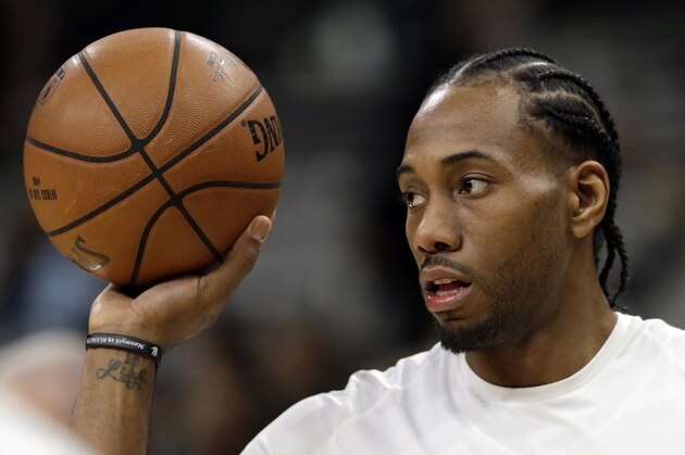 FILE - In this Jan. 5, 2018, file photo, San Antonio Spurs forward Kawhi Leonard handles a ball before an NBA basketball game against the Phoenix Suns in San Antonio. Two people familiar with the situation say San Antonio and Toronto have reached an agreement in principle on a trade that will send Kawhi Leonard to the Raptors and DeMar DeRozan to the Spurs. One of the people says the Spurs also are sending Danny Green to the Raptors as part of the deal. Both people spoke to The Associated Press on condition of anonymity Wednesday, July 18, 2018, because the deal has not been finalized. (AP Photo/Eric Gay, File)