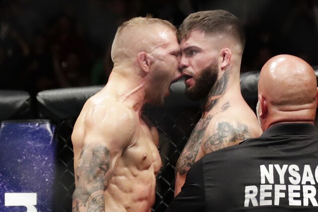 TJ Dillashaw celebrates after beating Cody Garbrandt, right, during a bantamweight title mixed martial arts bout at UFC 217 Sunday, Nov. 5, 2017, in New York. Dillashaw won the fight. (AP Photo/Frank Franklin II)