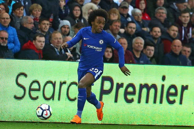 Chelsea's Brazilian midfielder Willian runs with the ball during the English Premier League football match between Swansea City and Chelsea at The Liberty Stadium in Swansea, south Wales on April 28, 2018. - Chelsea won the game 1-0. (Photo by Geoff CADDICK / AFP) / RESTRICTED TO EDITORIAL USE. No use with unauthorized audio, video, data, fixture lists, club/league logos or 'live' services. Online in-match use limited to 75 images, no video emulation. No use in betting, games or single club/league/player publications. /         (Photo credit should read GEOFF CADDICK/AFP/Getty Images)
