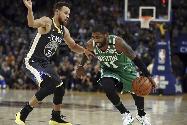 Boston Celtics' Kyrie Irving, right, drives the ball against Golden State Warriors' Stephen Curry duringing the second half of an NBA basketball game Saturday, Jan. 27, 2018, in Oakland, Calif. (AP Photo/Ben Margot)