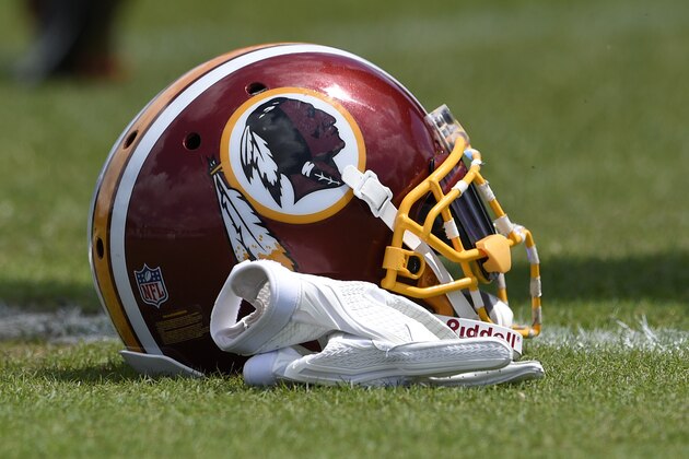 A Washington Redskins football helmet lies on the field during an NFL football team practice, Wednesday, June 6, 2018, in Ashburn, Va. (AP Photo/Nick Wass)